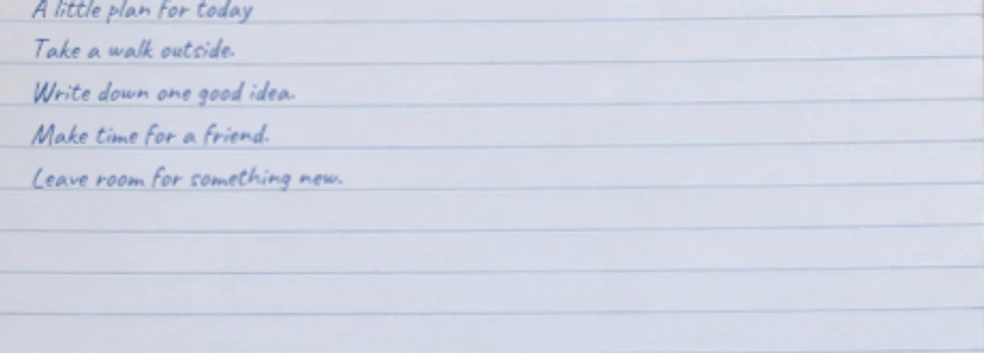 Close-up of Caveat handwriting aligned with the notebook ruling